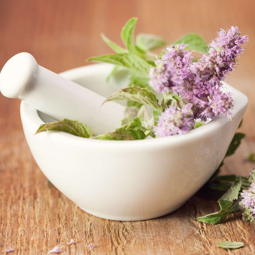 a mortar and pestle with lavender flowers in it