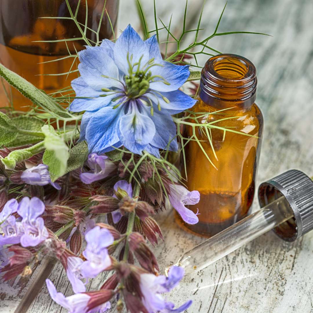 essential oils and flowers on a wooden table